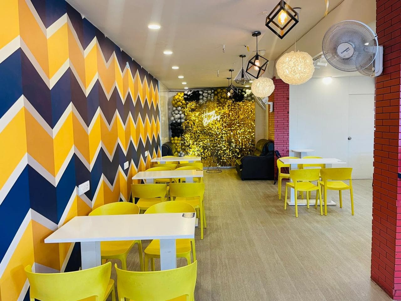 Bright café seating area with marble tables and white tiled walls